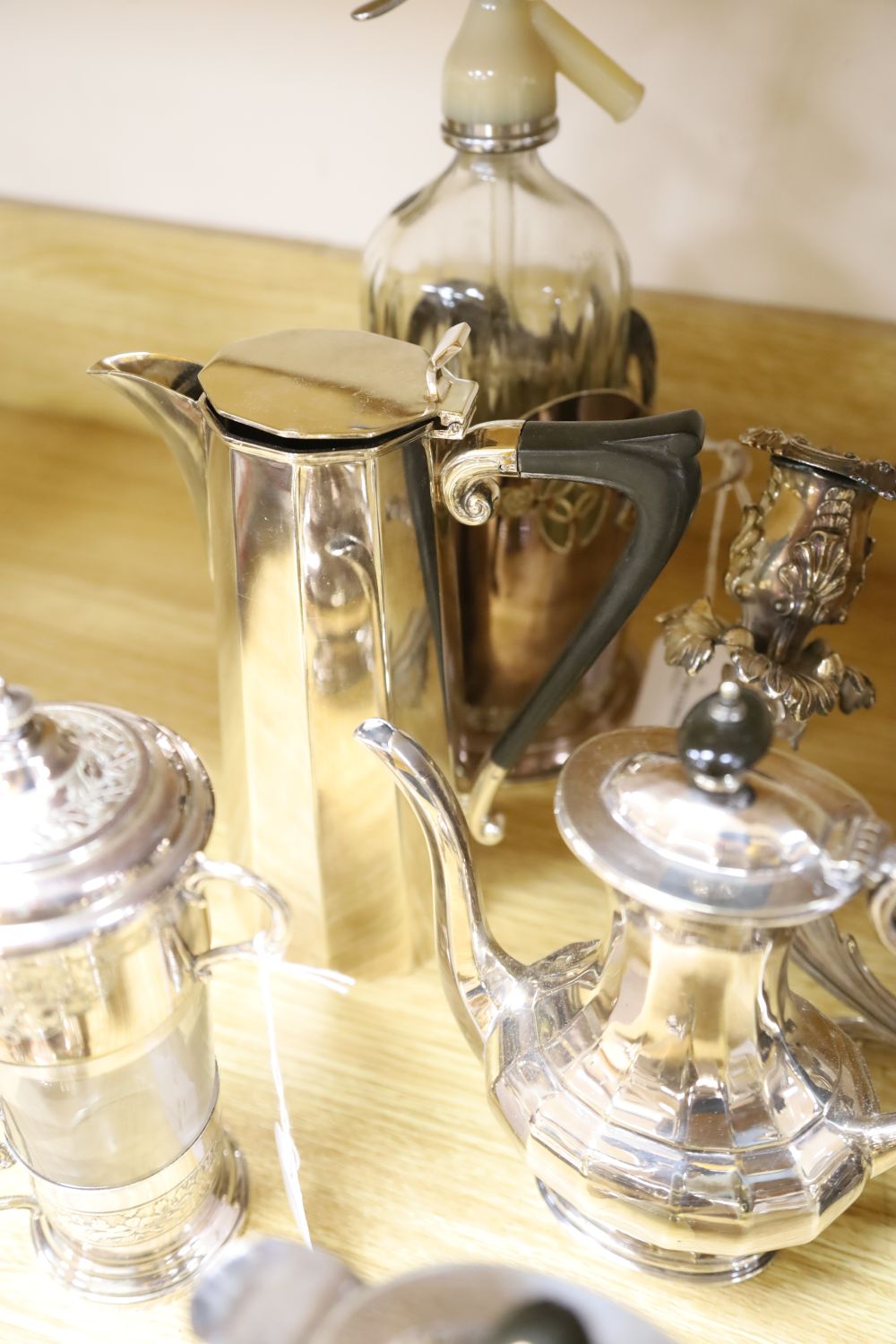 An ornate three-branch plated candelabrum with tulip sconces and sundry plated items,